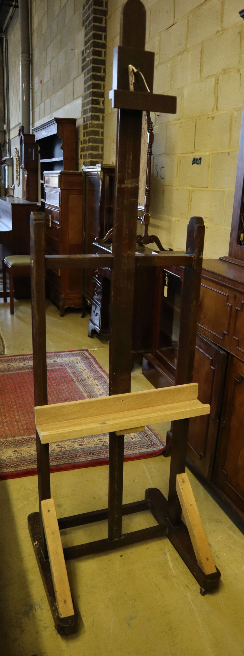 An early 19th century oak studio artists easel, width 55cm (incorporates later timber)